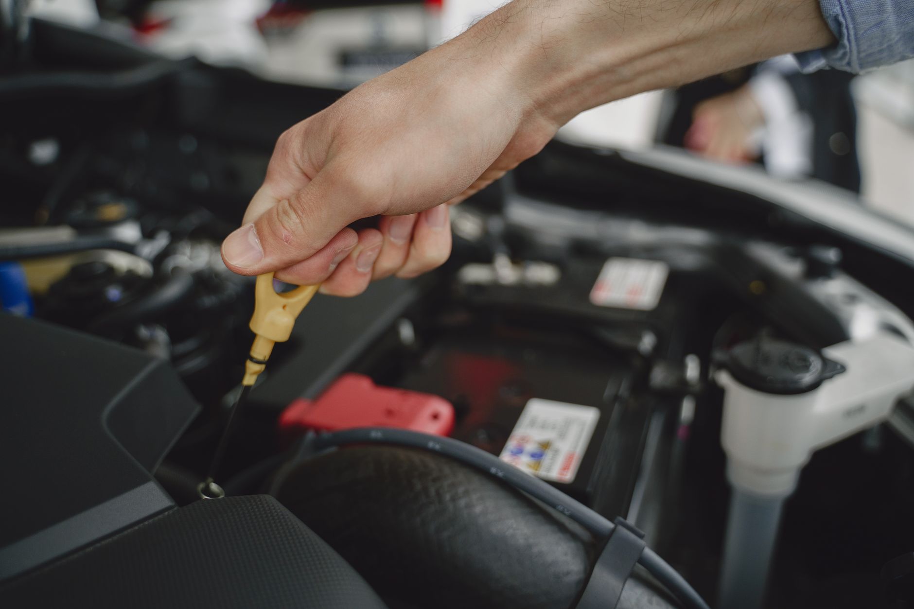 Mechanic reviewing service records to check for service history gaps on a used car